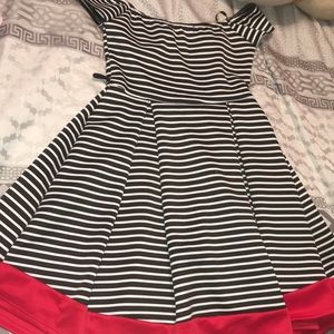 A black and white striped dress with red trimming